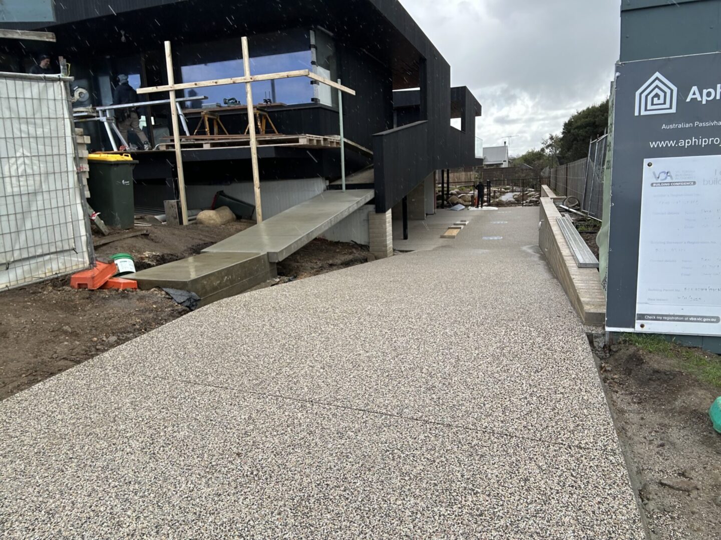 Construction site with pathway and modern building.