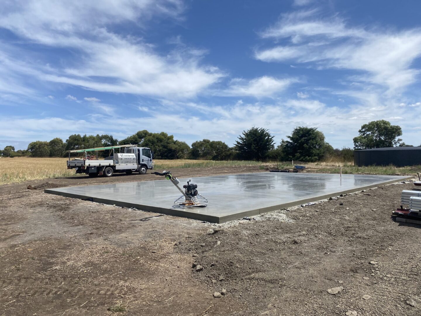 Concrete slab with construction equipment and truck.